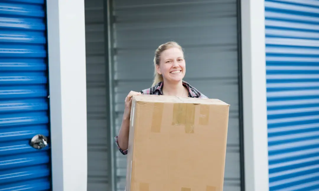 Customer placing a box into a storage unit