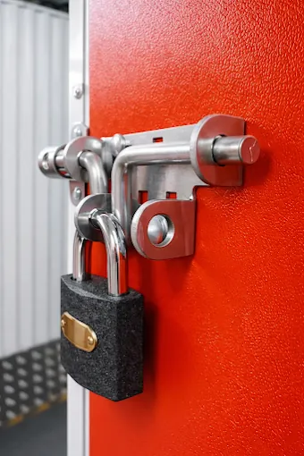 Heavy duty padlock securing a storage unit door